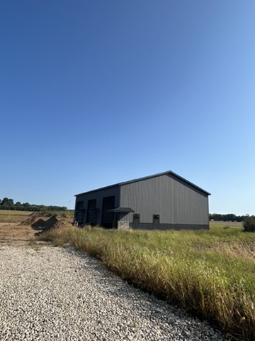 Building exterior with gravel approach and landscaping in progress
