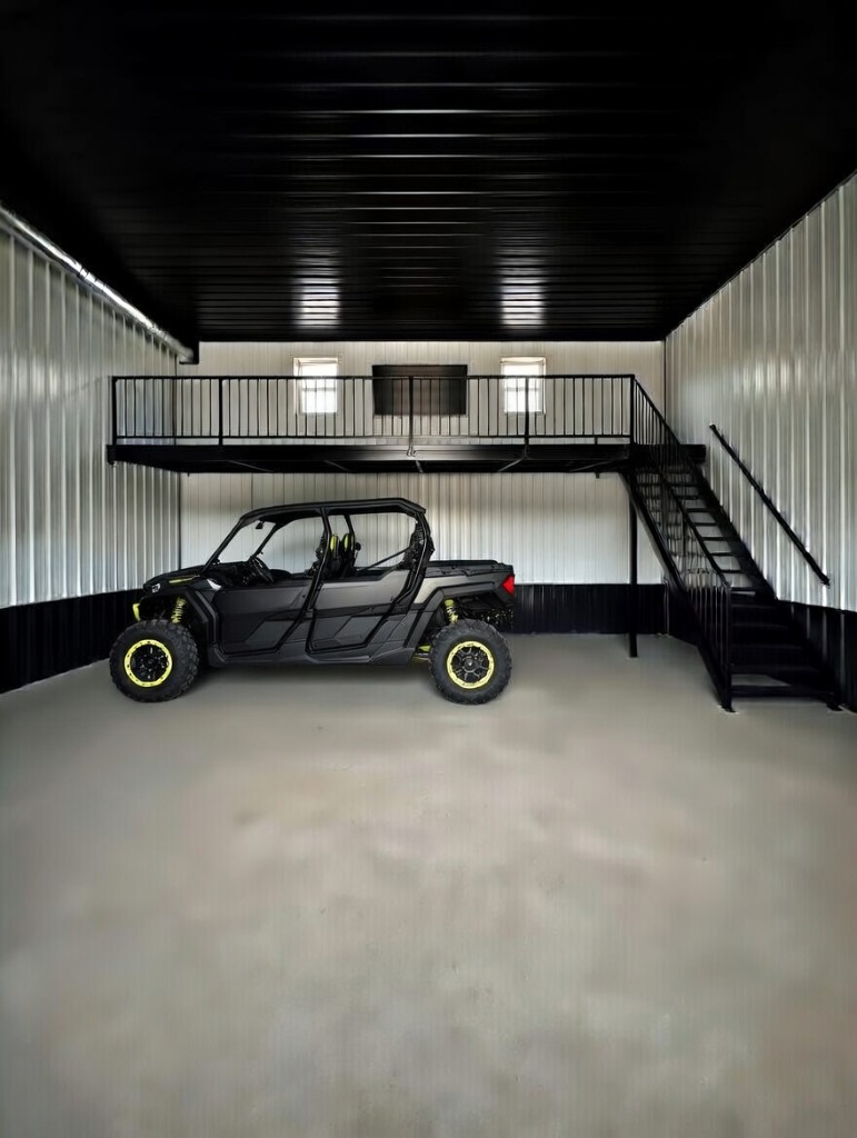 Diamond Garage Condo interior: black four-door UTV inside unit with corrugated walls and mezzanine